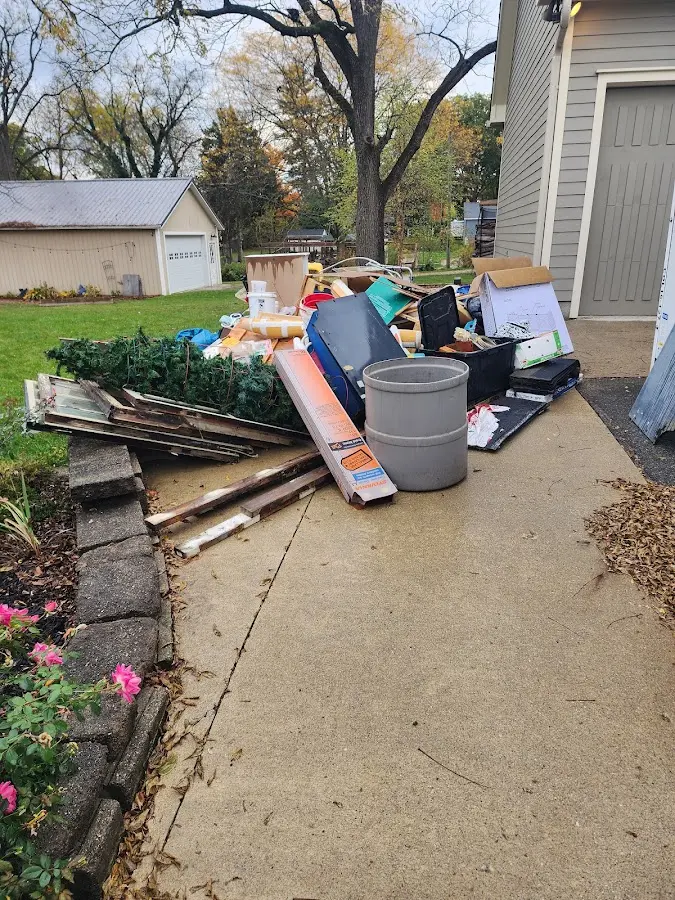 Dumpster being loaded with debris for 12 Yard Dumpster Rental in Oakfield